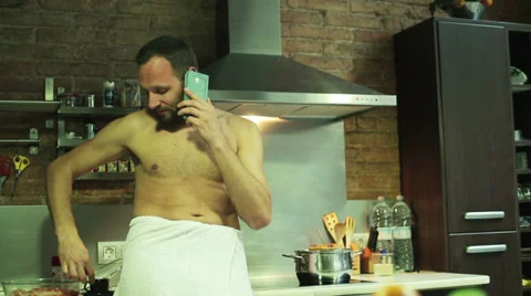 Man in a towel drinking coffee and standing in the kitchen Stock-Footage 36780005