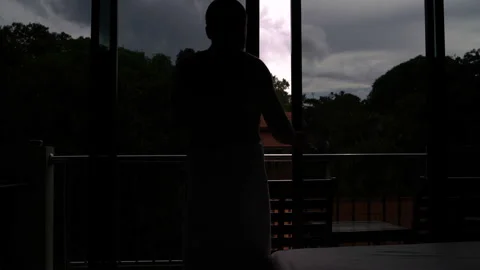 A man in a towel opens the panoramic door and opens onto a balcony Stock Footage 91786059