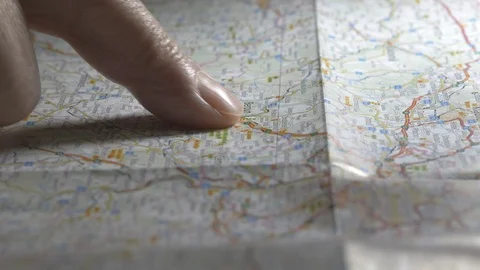 Man Traces Route On Map Reading And Taps A Spot 스톡 동영상 100641500