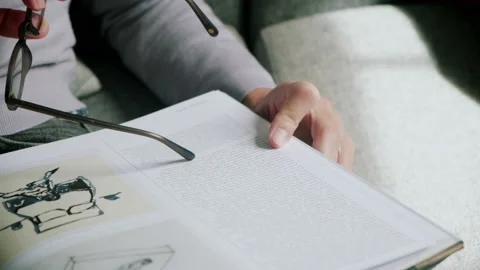 Man tracing text from book with glasses frame Stock Footage 130637889