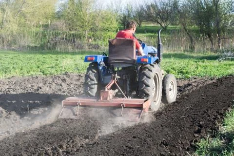 Man on the tractor, back view Stock Photos