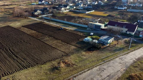 A man on a tractor digging the ground. Tractor driver plowing the field. Stock Footage 213468520