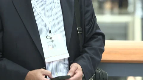 Man at trade show types on mobile phone Stock Footage 49387001