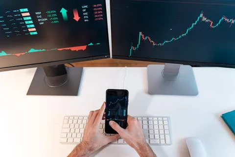 Man trader analyzing indexes at computer, investor broker, financial chart Stock Photos