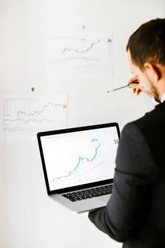Man trader bitcoin data price trend analysing Stock Photos
