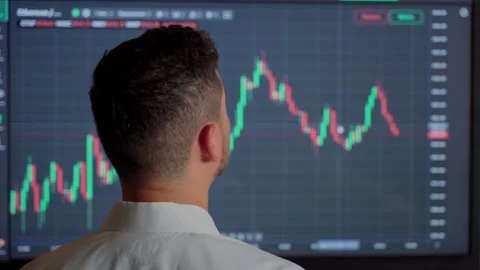 Man trader looking at graph currency money at screen indoors Stock Footage 157455567