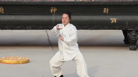 Man in traditional clothes of china practicing Tai Chi in temple Stock Footage 24658108