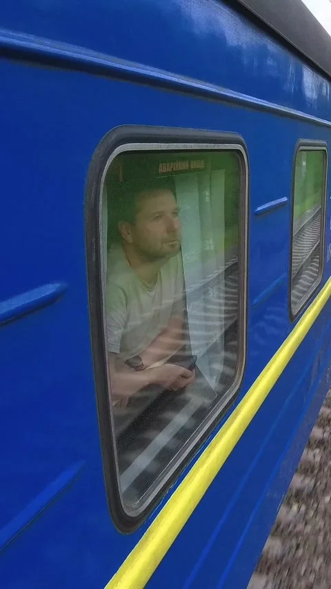 Man in Train Car Observing the Scenic Ukrainian Landscape Stock Footage 288104766
