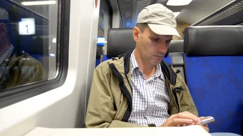 Man in a train looking to smartphone 스톡 동영상 85428659