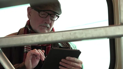 Man on train reading tablet Video stock 48706146