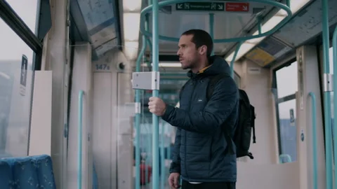 Man on the train standing and looking through window worried Stock Footage 130982235