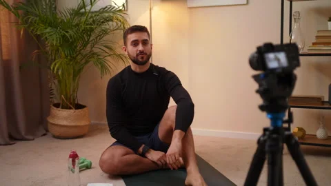 Man Trainer Sits During Quarantine At Home And Records Himself During Training Video stock 145240037