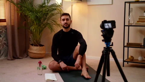 Man Trainer Sits During Quarantine At Home And Records Himself During Training Stock Footage 145240907