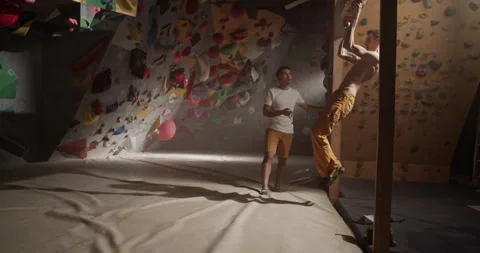 Man trainer testing climber endurance hang time with stopwatch Stock Footage 259984233