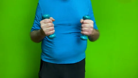 Man training arms with light dumbbells focusing on strength fitness. Stock-Footage 340252636