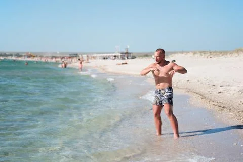 Man in training on beach Stock Photos