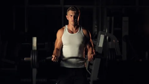Man training biceps with barbell 스톡 동영상 77877719