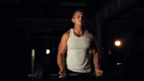 Man training biceps with determination 스톡 동영상 77878221