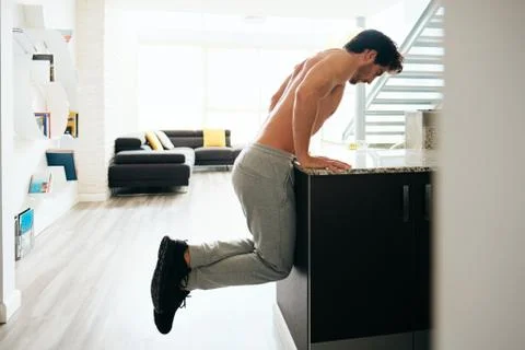 Man Training Chest Doing Low Chest Push-Ups On Kitchen Counter Stock Photos