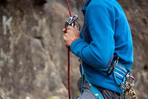 Man is training, climbing in the mountains. Stock Photos