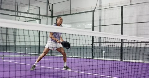 Man training on court with paddle lunging forehand volley switching backhand Stock Footage 337293868