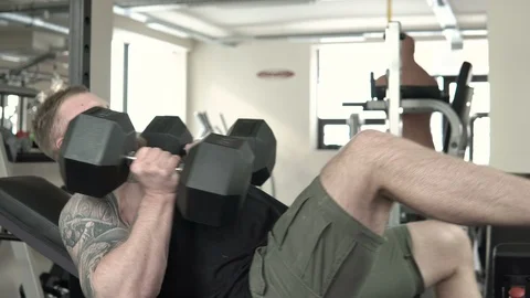 A man is training with dumbbells close-up 4k. Stock Footage 85589421