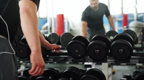 Man training with dumbbells Stock Footage 62447133
