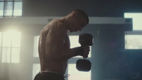 Man training with dumbbells Stock Footage 236179875