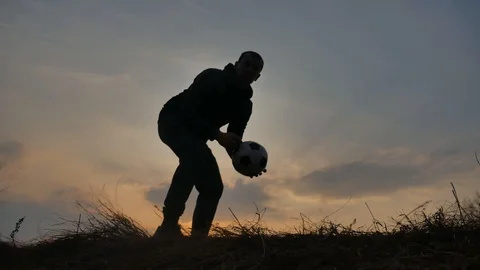 Man is training freestyle bal Hacky On Sunset Sack silhouette freestyle concept Stock Footage 103318199
