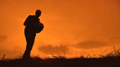 Man is training freestyle bal Hacky On Sunset Sack silhouette freestyle concept Stock Footage 105849284