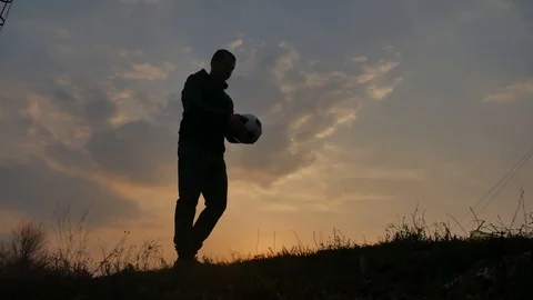Man is training freestyle bal Hacky On Sunset Sack silhouette freestyle concept Stock Footage 107745357