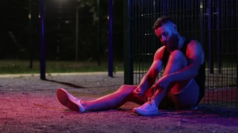 Man training outdoor at night at local sports ground Stock Footage 135804012