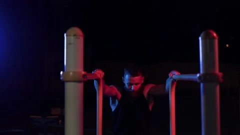 Man training outdoor at night at local sports ground Stock Footage 135804317