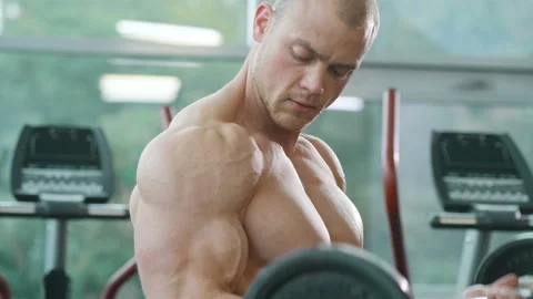 Man training pumping up biceps muscles Video stock 148356018