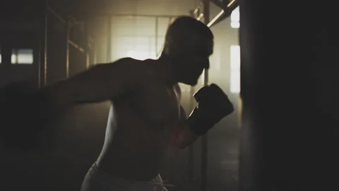 Man training with punching bag Video stock 236192866