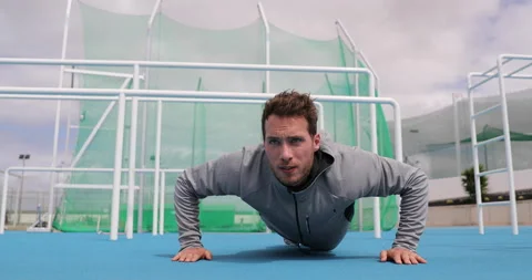 Man training push ups doing strength training outdoors. Fit muscular male Stock Footage 220144453