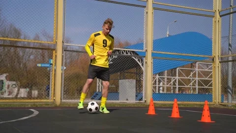 Man is Training Soccer Skills And Ball Tricks.  Ball Control and Footwork Stock Footage