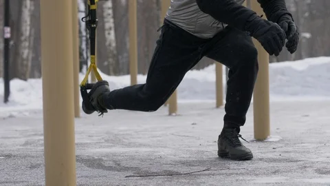 Man training squat exercise and jump exercise with fitness expander outdoor Stock Footage 87961124