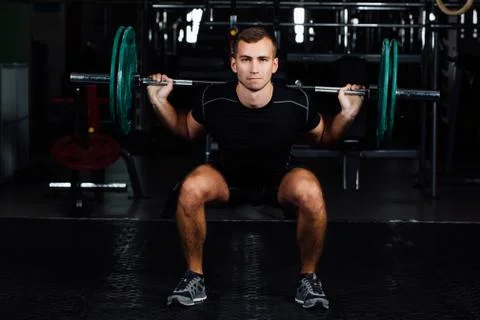 Man training squats with barbells over head Stock Photos