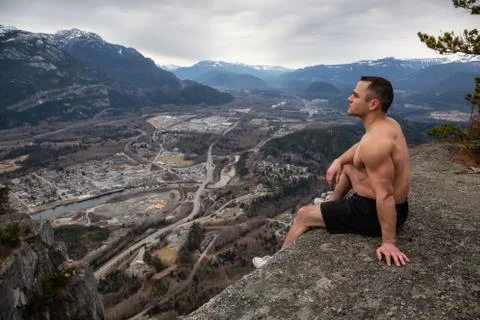 Man training on top of a mountain Stock Photos