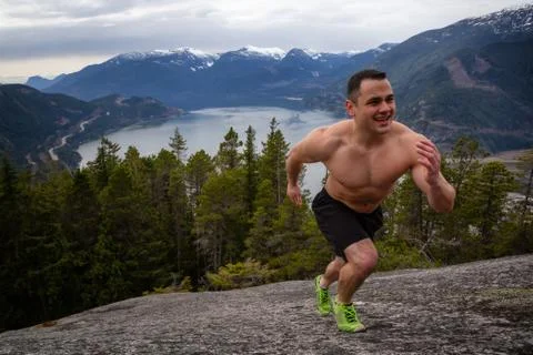 Man training on top of a mountain Stock Photos