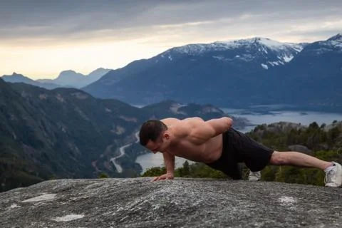 Man training on top of a mountain Stock Photos