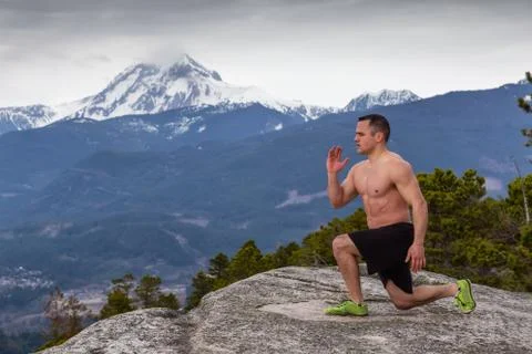 Man training on top of a mountain Stock Photos
