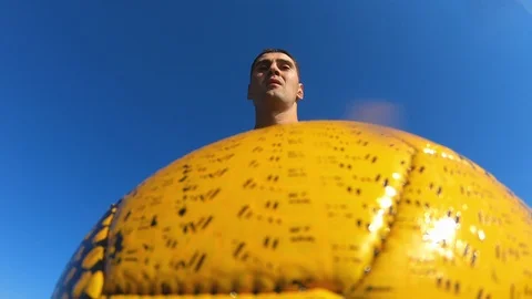 A man trains with a ball about throws it into the water.Sport. Stock Footage 96991048