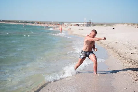 A man trains on the beach Stock Photos