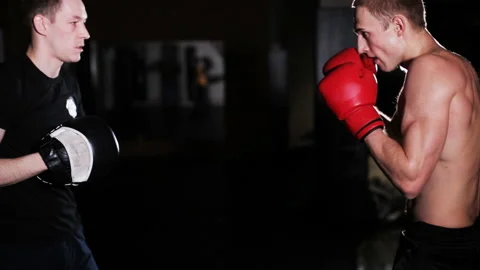 Man Trains Boxing with Trainer Stock Footage 86554614
