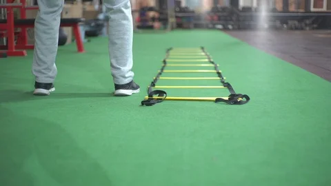 Man trains on coordination ladder Stock-Footage 104920548