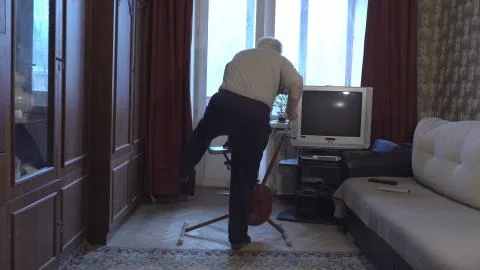 A man trains on an exercise bike while at home during the epidemic Stock Photos