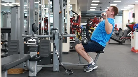 A man trains in the gym. Does exercise for back muscles Stock Footage 102227514