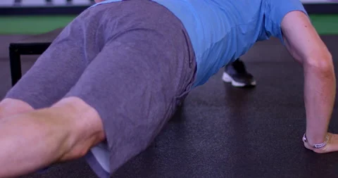 Man trains in gym doing one handed push up stretches - close up on hands Stock Footage 148246483